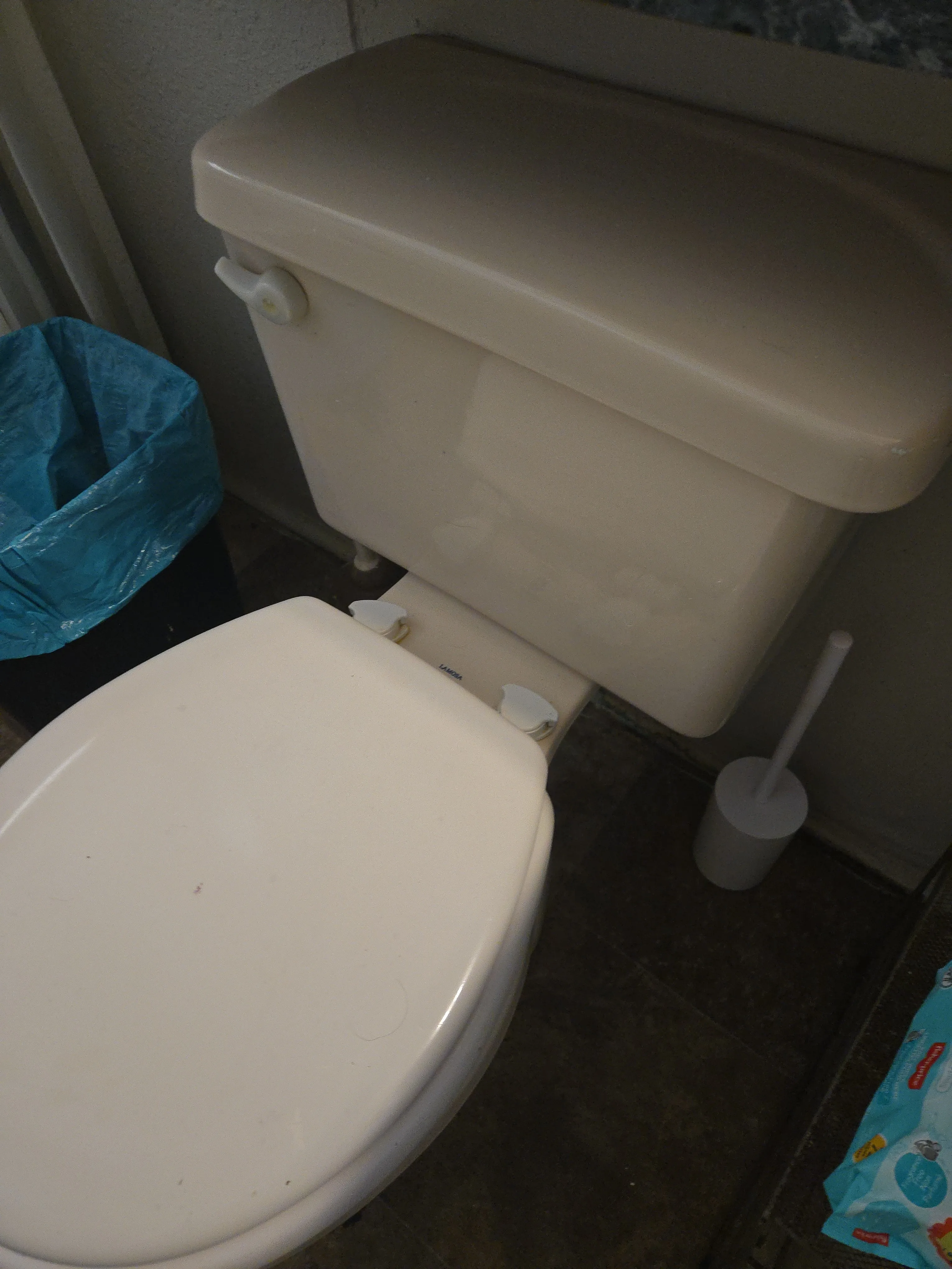 Bathroom toilet area after cleaning with fixtures and floor reset