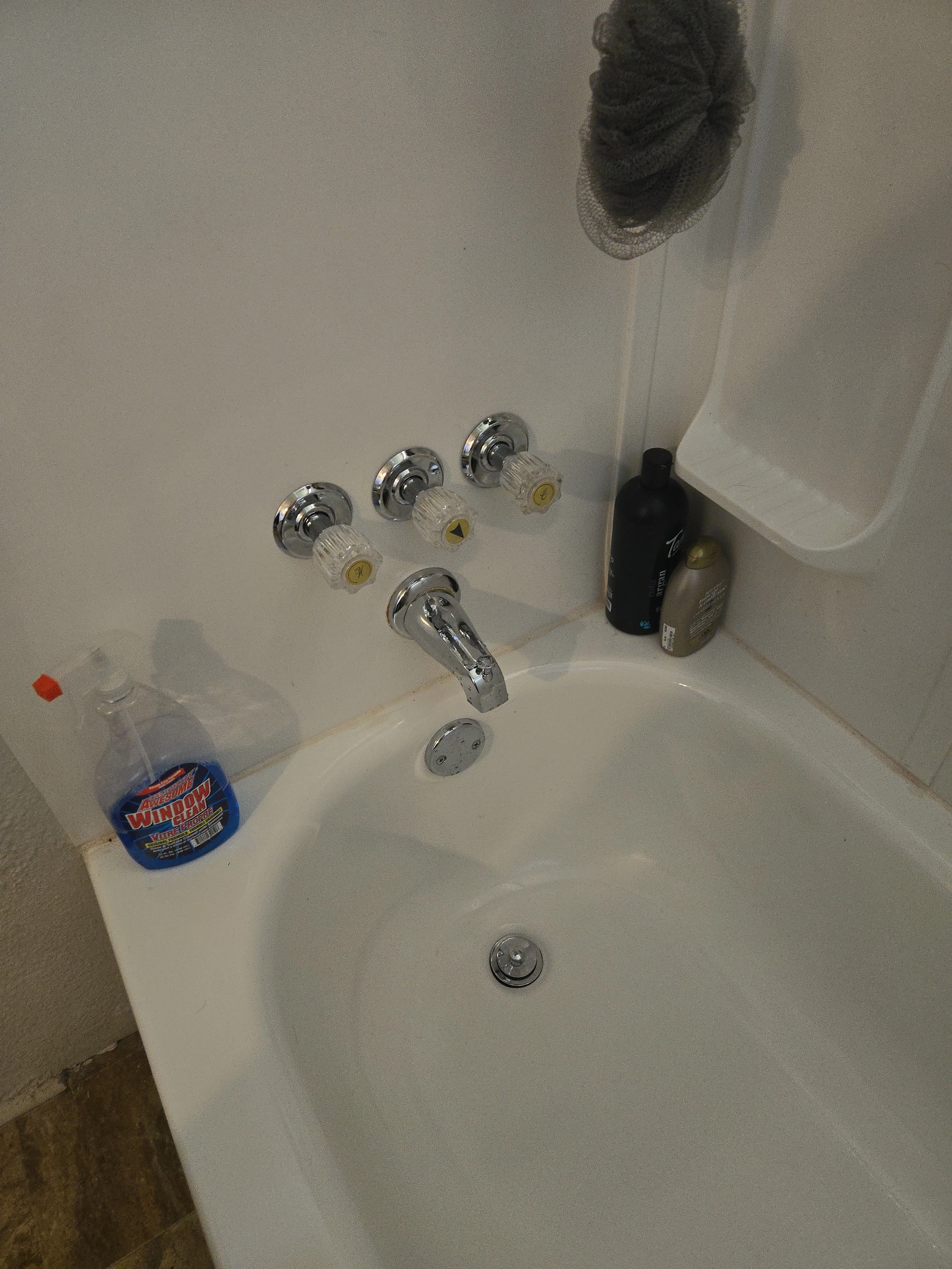 Bathtub after cleaning from the same angle with the tub and fixtures reset