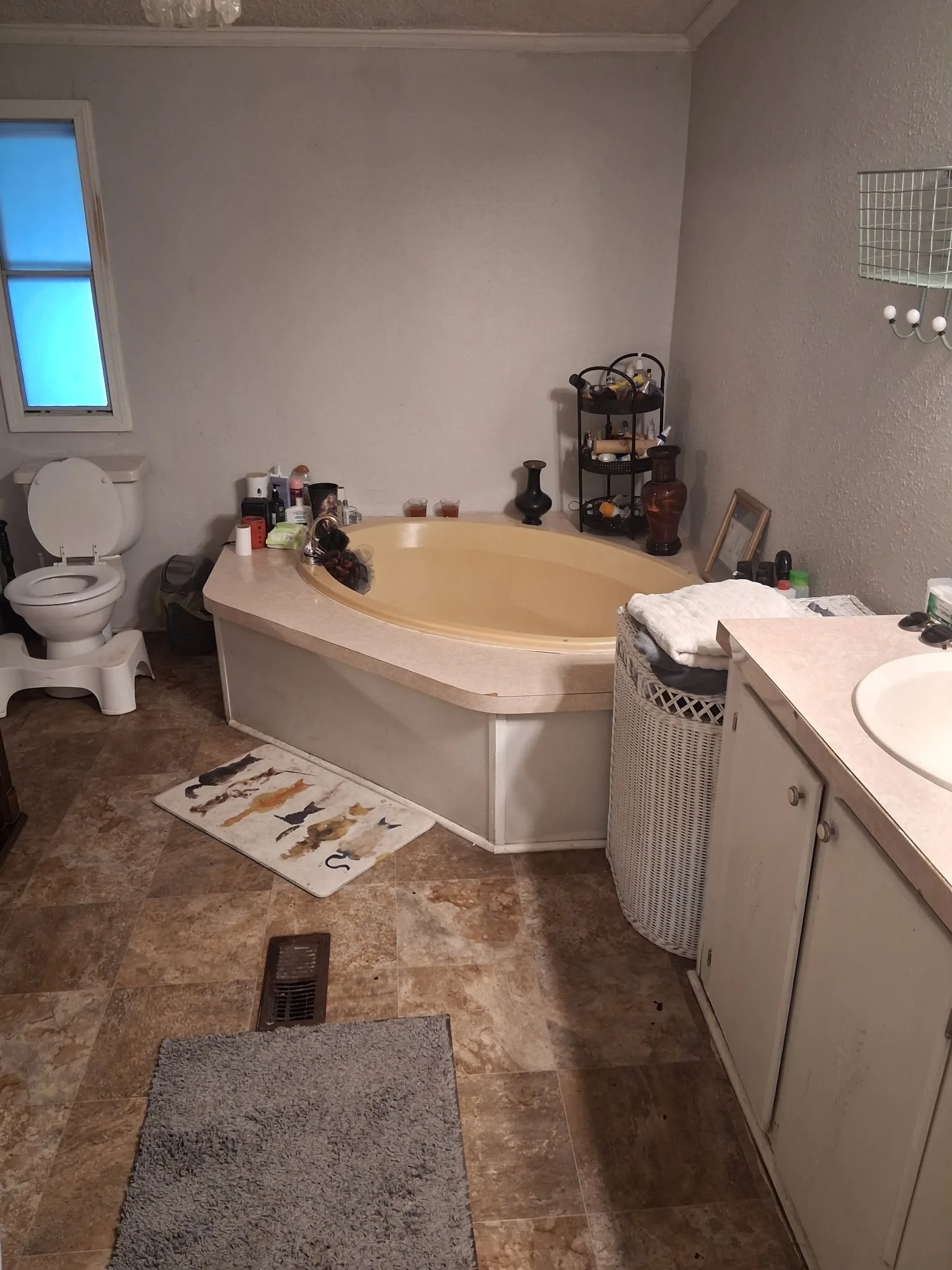 Primary bathroom after cleaning with surfaces reset and the room picked up