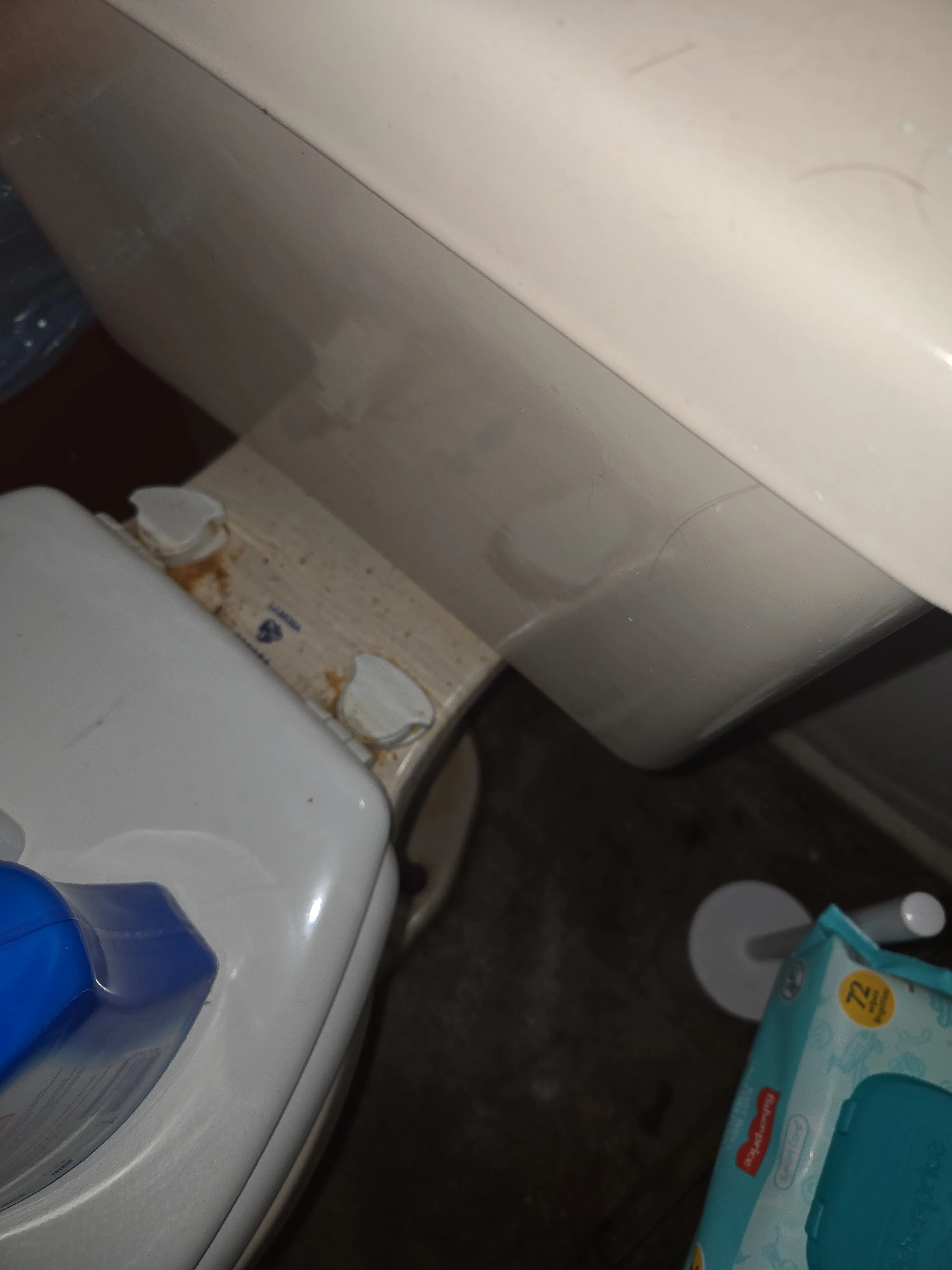 Bathroom toilet area before cleaning with visible residue and dust