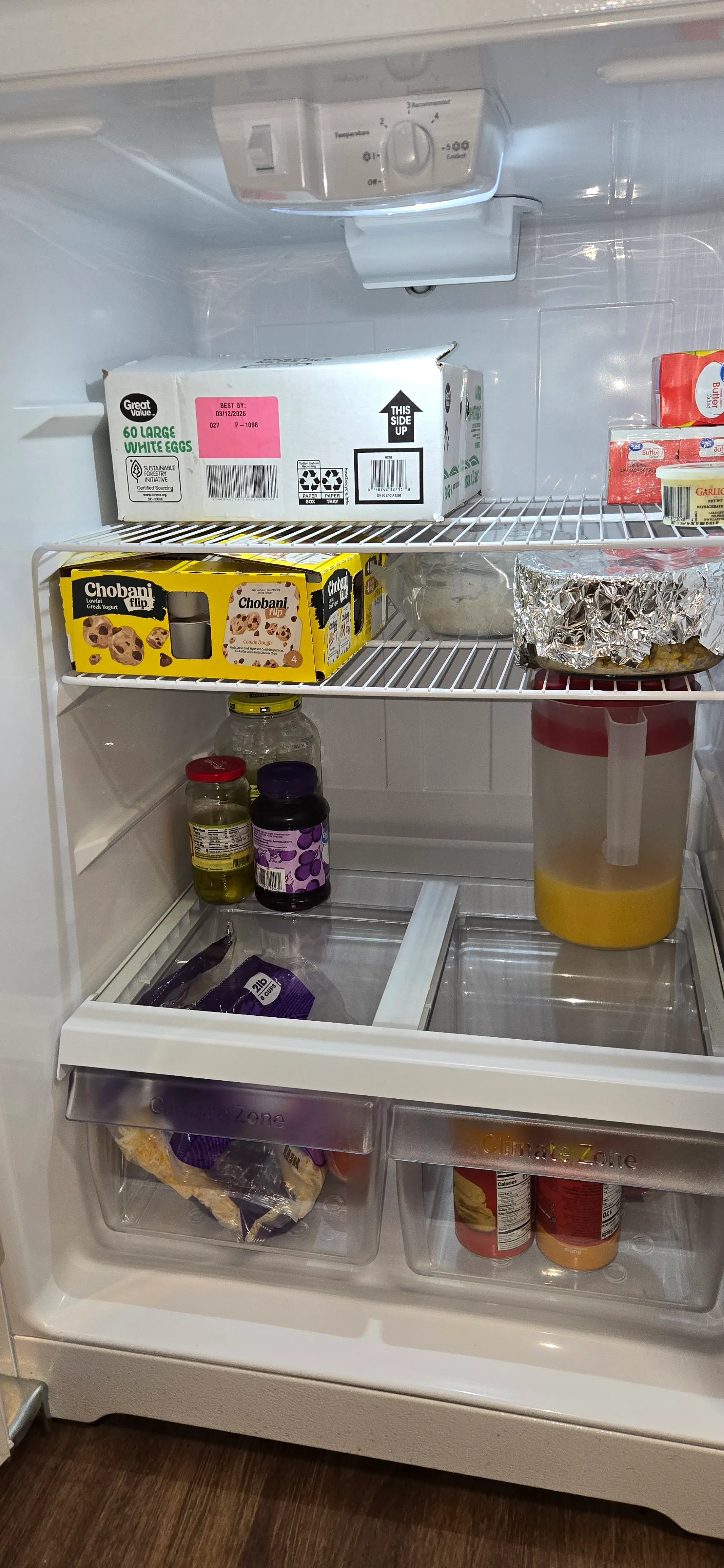 Refrigerator interior after cleaning with drawers wiped down and shelves reassembled