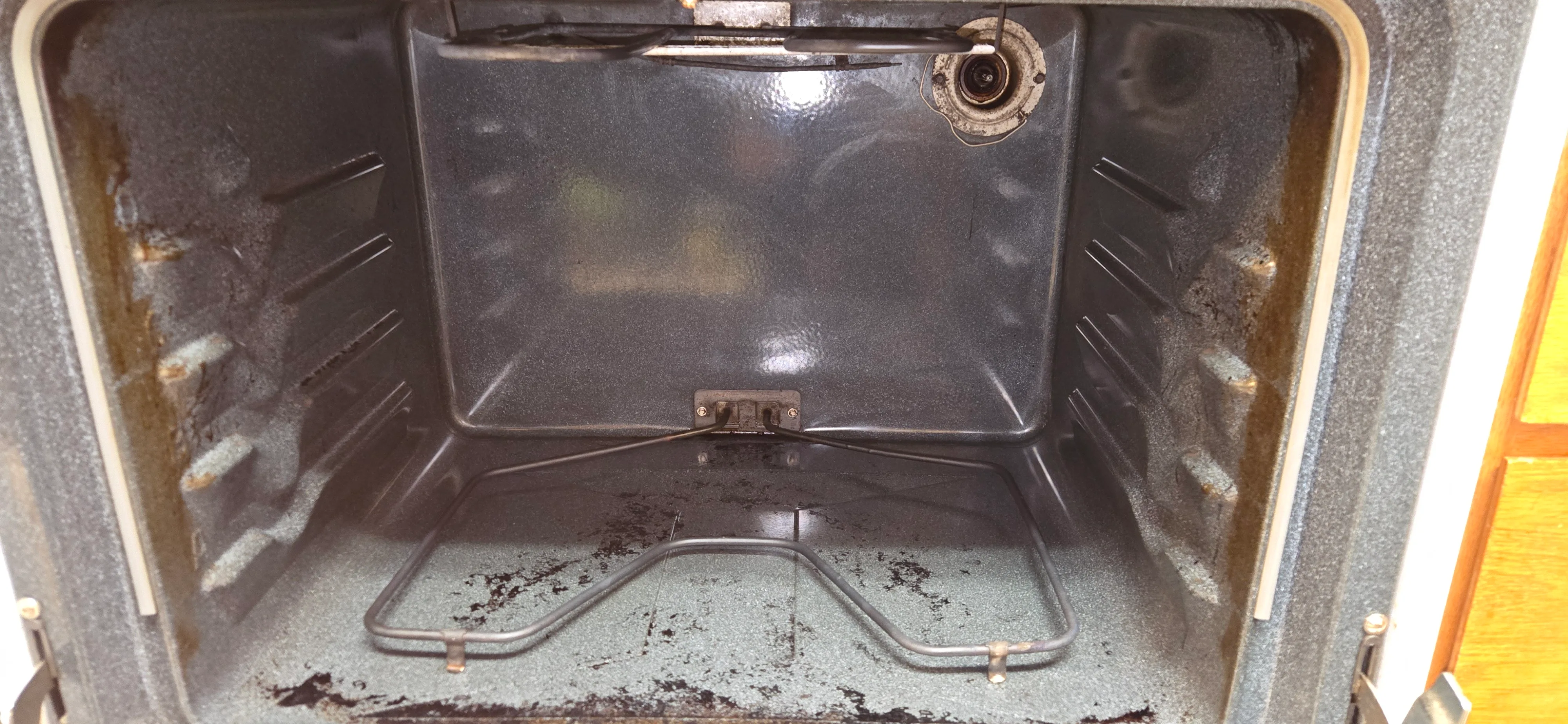 Oven interior after cleaning with the cavity visibly cleaner